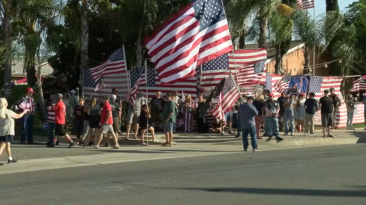 Kerry Sheron's Escondido home with a large American flag display and visitors.